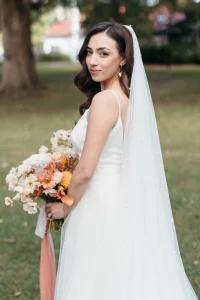 bridal portrait bride looking backyards carrying flowers